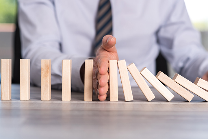 Business,Control,Concept,By,Stopping,Domino,Effect